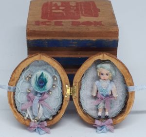 Tiny boy doll in walnut Little boy doll and tambourine in walnut shell